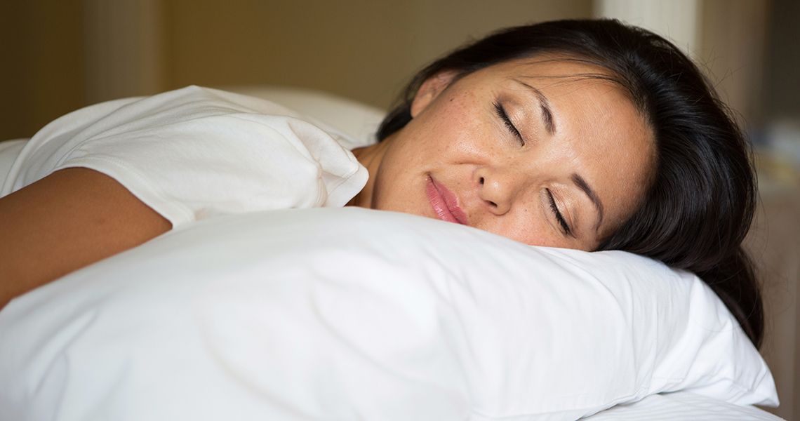 A woman sleeps on a pillow